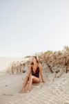 woman sitting on sand