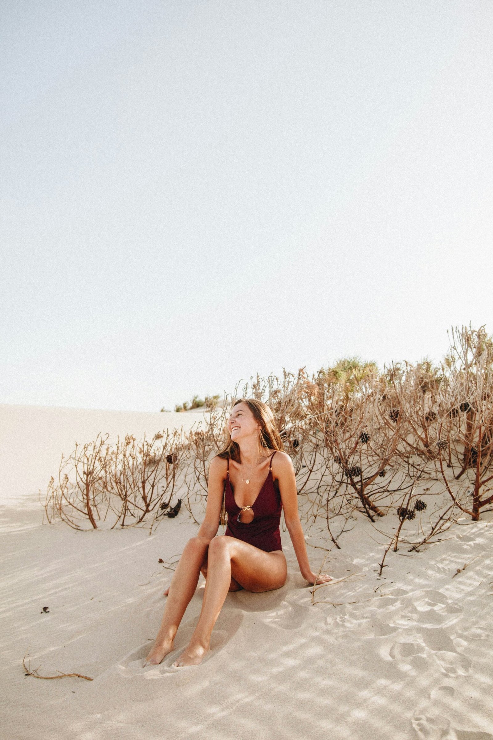 woman sitting on sand